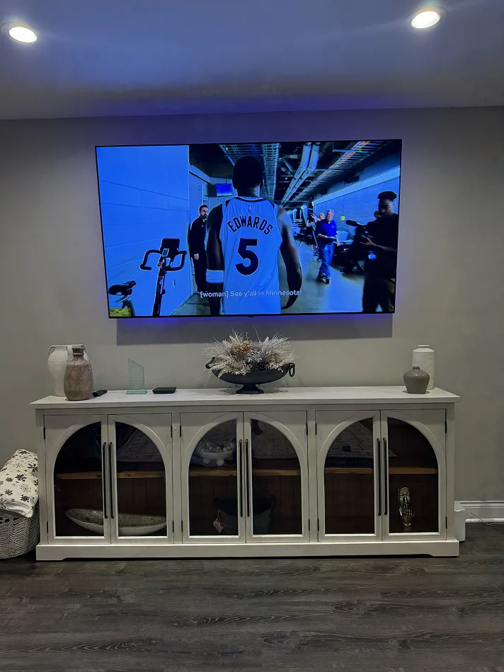 TV mounted above an arched white console