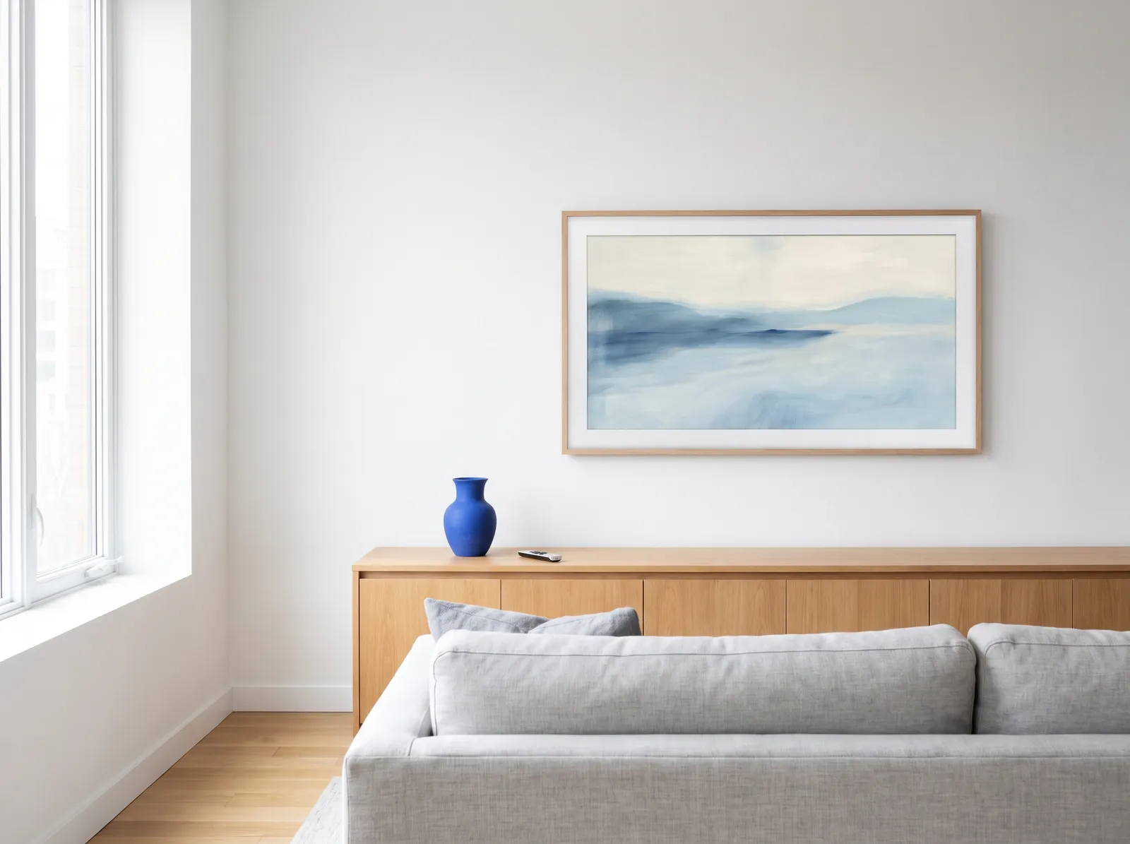 Art TV showing a painting above an oak sideboard, with no cables below it
